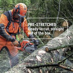 a man in an orange and black outfit cutting down a tree with a chainsaw