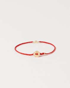 Scosha 2mm evil eye bracelet features gold tiny eye charm accented with 1mm turquoise stone on braided waxed nylon in scarlet. Gold signature button closure. Dimensions: 6.75" long Material: Nylon, 10k gold, turquoise Origin: Brooklyn, NY Why we Covet: Beautifully simple Eye Bracelet, Evil Eye Bracelet, 10k Gold, Turquoise Stone, Delicate Bracelet, Evil Eye, Scarlet, Gold Bracelet, Turquoise