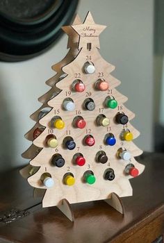 a wooden christmas tree with buttons on it