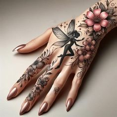 a woman's hand painted with flowers and a fairy on the left side of her arm