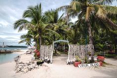 a beach with palm trees and a sign that says virgin island on it's side