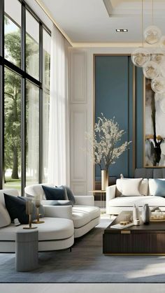 a living room filled with lots of white furniture and large window covered in glass doors