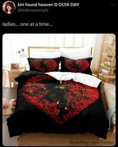 a bed with black and red comforters on it