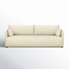 a white couch with two pillows on it