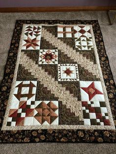 a quilt is laying on the floor next to a table