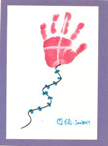 a handprint is shown on a card with blue string attached to the bottom of it