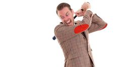 a man in a suit holding a red frisbee and making a funny face