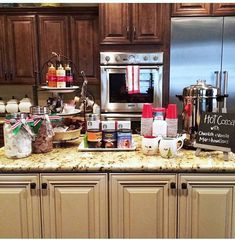 the kitchen counter is covered with coffee and condiments, including hot chocolate bars