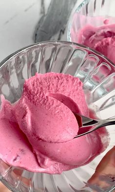 two bowls filled with pink ice cream on top of a table