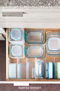 the drawers are organized with clear plastic containers and dividers to keep food from falling