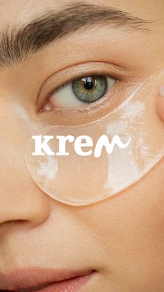 a close up of a person holding a magnifying glass with the word krem on it