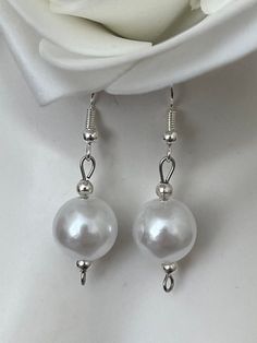 Ivory Pearl drop earrings. Add a touch of elegance to your wardrobe with these timeless dangle drop earrings. Handmade with love to elevate any look. Sterling silver ear hook with faux pearl drop. Free shipping to UK buyers. Dispatched within 1-3 days but I aim to post by the following day.  Presented on a gift card and wrapped beautifully in luxury tissue paper and a blush pink organza bag making them the perfect gifts for loved ones.  If you aren't completely in LOVE with your purchase, please let me know and you'll receive a stress free refund. Customer satisfaction is my main priority.  These are perfect for any occasion, weddings, brides, bridesmaids or gifts.  Thank you for viewing. Please ask any questions, I am always available to help. I have many pieces available in my shop, plea Classic White Pearl Earrings For Party, Adjustable White Pearl Earrings For Anniversary, Adjustable White Pearl Earrings For Wedding, Delicate White Pearl Earrings For Bridesmaids, Delicate White Pearl Earrings For Mother Of The Bride, French Hook Wedding Earrings, Wedding Earrings With French Hook, Wedding Earrings With French Hook In Round Shape, Wedding French Hook Round Earrings