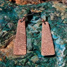 Created by the artists at Alta Studios these Copper Earrings are hand crafted high in the mountains of Northern New Mexico. Made from 24 ga. Copper and with surgical steel earwires. We hand form, hand texture and metalsmith all the materials for a truly unique piece of art! Each piece is hand made - Item shipped may vary slighty from item shown in pictures. Approx. 3/8" wide x 1 1/4" tall Shipping Weight 8 oz. Copper Earrings, Metal Jewelry, Dog Tag Necklace, Custom Jewelry, Design Elements, Unique Pieces, Copper, Art Pieces, Jewelry Making