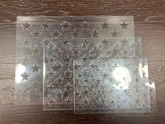 two clear plates with silver stars on them