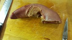 a knife and some meat on a cutting board