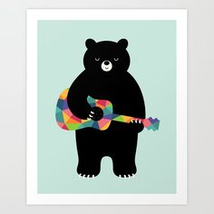 a black bear holding a colorful guitar