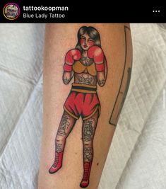 a woman with tattoos on her leg wearing boxing gloves