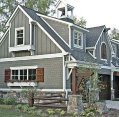 a gray house with white trim and brown shutters