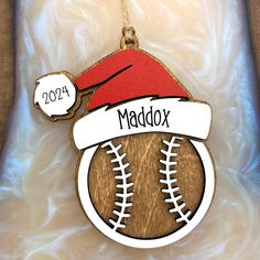 a wooden ornament with a baseball and santa hat on it's head