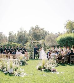 a bride and groom standing at the end of their wedding ceremony