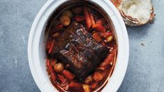 a pot roast with carrots, potatoes and bread