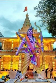 a statue in front of a large building