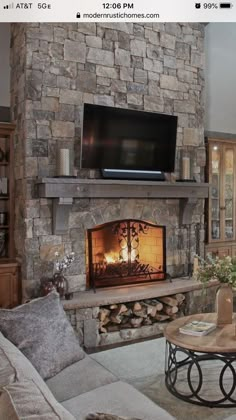 a living room filled with furniture and a flat screen tv mounted above a fire place