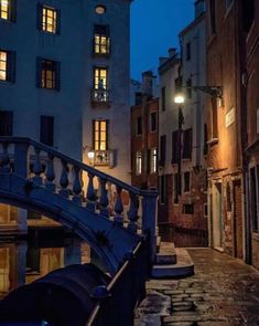 a bridge that is over some water in the middle of a street with buildings on both sides