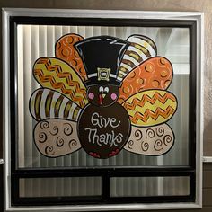 a window with a thanksgiving turkey painted on it's side and the words give thanks