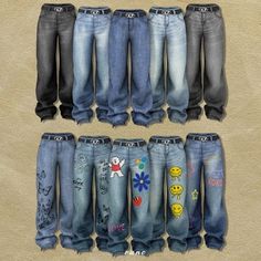 several pairs of jeans with embellishments on them are arranged in a row