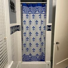 a bathroom with a blue and white shower curtain