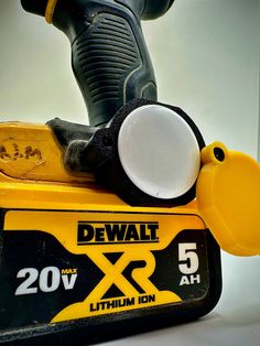 a close up of a power tool on top of a sign that says dewt