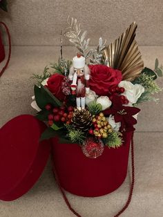 a christmas arrangement in a red hat box