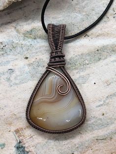 Copper wire wrapped yellow banded agate pendant Will come with a black corded necklace Luxury Wire Wrapped Agate Necklace, Corded Necklace, Copper Work, Wire Wrapped Stone Jewelry, Wire Wrapping Stones, Sun Designs, Banded Agate, Agate Pendant, Cord Necklace