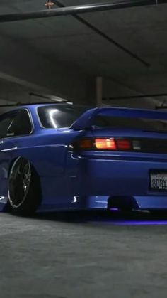 a blue car parked in a parking garage