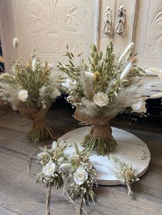 three bouquets of flowers are sitting on the floor