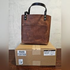 An Absolutely Gorgeous Bnnu Classic Tote In English Tan With Natural Color Variation In The Leather. Still Filled With Tissue Paper And It Will Be Shipped In The Original Box! Brown Waxed Canvas Shoulder Bag With Leather Backing, Brown Leather Shoulder Bag With Waxed Finish, Everyday Vintage Brown Bags With Leather Backing, Light Brown Leather Shoulder Bag With Leather Trim, Brown Oiled Leather Bag With Leather Handles, Vintage Brown Textured Leather Bag For Everyday Use, Brown Leather Bag With Waxed Finish, Light Brown Leather Bags With Leather Trim, Everyday Tan Leather Shoulder Bag