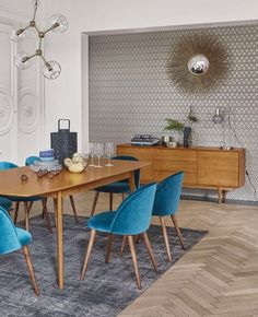 a dining room with blue chairs and a wooden table