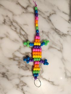 a colorful lizard made out of beads on a marble surface