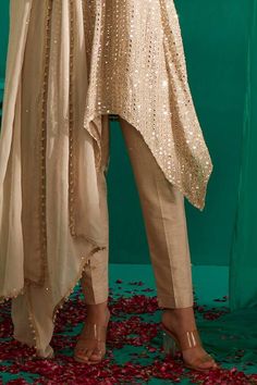 Ivory gold asymmetric kurta with all over mirror, pearl, thread embroidery. Paired with a straight pant and dupatta with sequin work. - Aza Fashions Elegant Gold Palazzo Set For Party, Chic Festive Set With Traditional Drape, Chic Festive Sets With Traditional Drape, Chic Wedding Palazzo Set For Festive Occasion, Chic Wedding Festive Palazzo Set, Gold Straight Kurta Palazzo Set For Reception, Gold Palazzo Set With Straight Kurta For Reception, Elegant Gold Palazzo Set With Dabka, Festive Chic Designer Palazzo Set