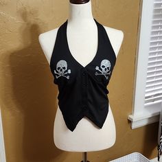 This Is A Cute Black Halter Top Nwot. This Halter Top Has Rhinestone Skull Crossbones Details Size Medium. Rock Style Black Party Tops, Rock Style Black Tops For Party, Gothic Party Tops With Skull Print, Black Skull Print Rock Top, Black Rock Style Tops For Halloween, Edgy Skull Print Top For Party, Edgy Skull Print Party Tops, Black Fitted Rock Style Tops, Halter Top Outfit