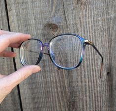 Super cool purple ombre eyeglass frames, 1980s vintage. Features a beautiful translucent purple/blue/green multicolored ombre fade, gold tone hardware, classic 80s 'secretary' style squarish shape, and lots of retro kitsch cool... The perfect all-occasion statement frames!  ;) Brand : Silhouette Model 2732 Currently have prescription lenses in place that will need to be replaced with your own 5 1/4 inches from temple to temple 1/2 inch nose bridge 1 7/8 inch frame height 2 1/8 inch frame width 4 inch arm length, measured up to the curve Prescription lenses are very scratched (but these will need to be replaced with your own prescription). Frames have some general wear, including a little scuffing and some slight looseness of the left arm (the screw most likely needs to be tightened).  Stil Square Ombre, Purple Silhouette, 80s Secretary, Purple Glasses Frames, Secretary Style, Purple Frame Glasses, Lilac Glasses Frames, Purple Glasses Square, Purple Eyeglasses