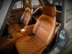 the interior of a car with brown leather seats