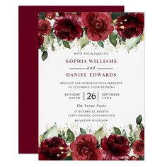 a wedding card with red flowers and greenery on the front, in burgundy tones