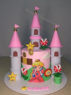 a pink cake decorated with princess's castle and stars