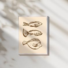 a card with three fish drawn on it's front and back sides in brown ink