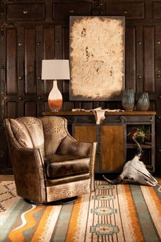 a living room filled with furniture and a large painting on the wall above a table