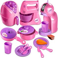 a pink and purple toy kitchen set with utensils, spoons, plates, cups, and other items