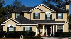 a house with green shutters and white trim