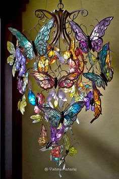 a chandelier made out of stained glass butterflies